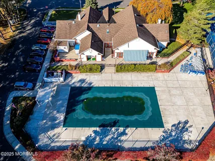 an aerial view of a house with a swimming pool and outdoor seating