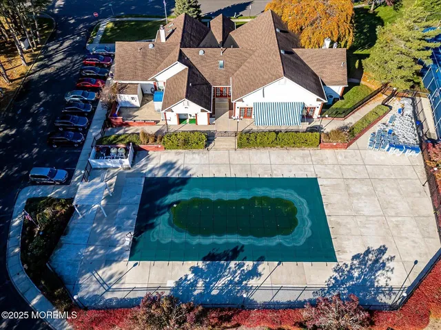 an aerial view of a house with a swimming pool and outdoor seating