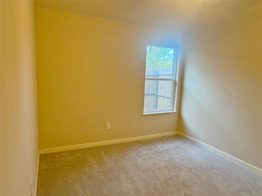 3912 Oneal Street Greenville, TX 75401 - Photo 11 of 20 a view of an empty room with a window