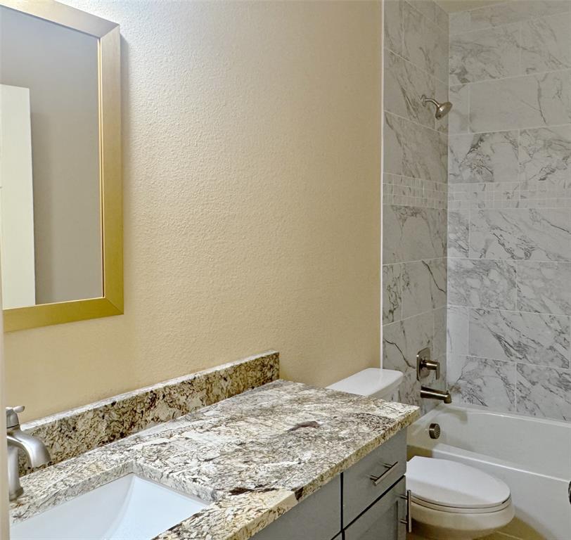 3912 Oneal Street Greenville, TX 75401 - Photo 12 of 20 a bathroom with a granite countertop sink toilet and shower