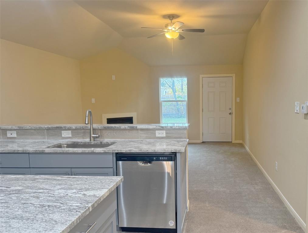 3912 Oneal Street Greenville, TX 75401 - Photo 6 of 20 a bathroom with a granite countertop sink a mirror and a vanity