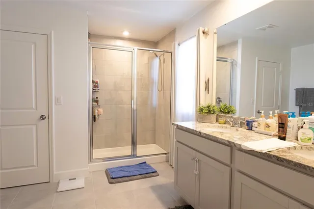a bathroom with a double vanity sink and mirror