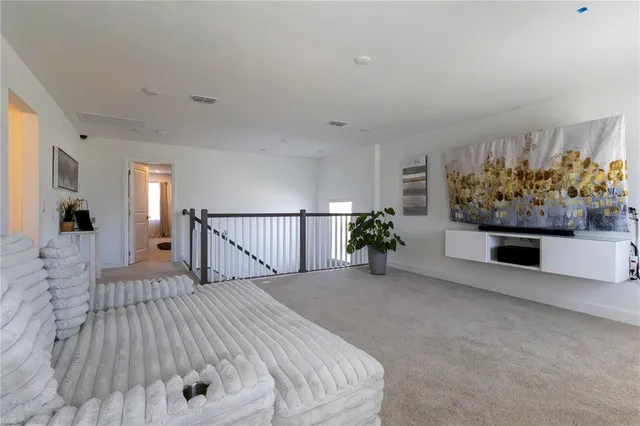 a view of a bedroom with wooden floor and stairs