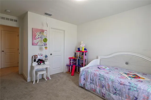 a bedroom with a bed and a cabinets
