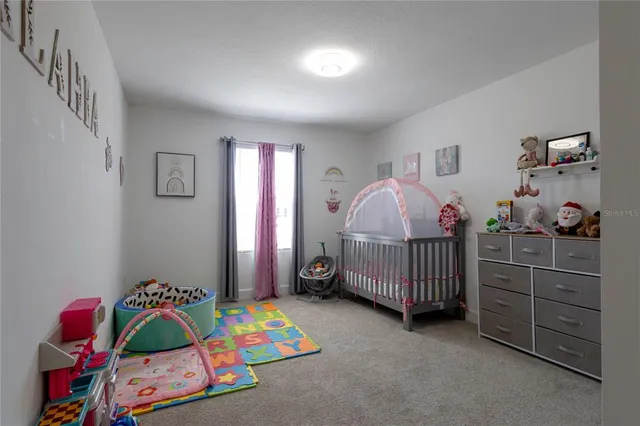 a bedroom with a bed and a baby crib