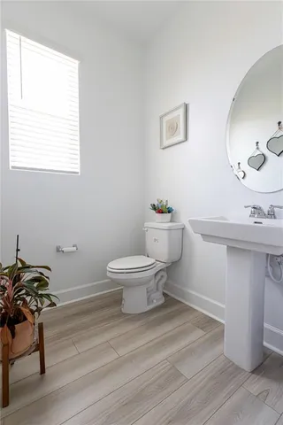 a bathroom with a sink toilet and a mirror