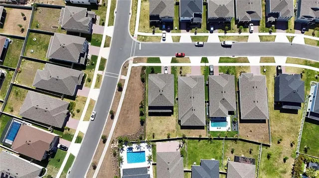 an aerial view of residential houses with outdoor space