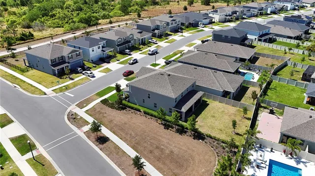an aerial view of a house with a swimming pool