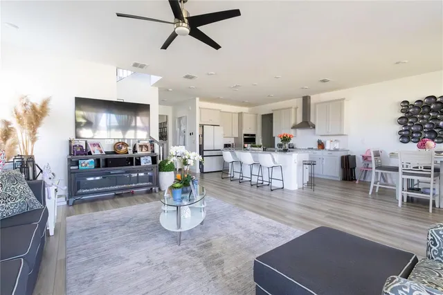 a living room with lots of furniture and kitchen view