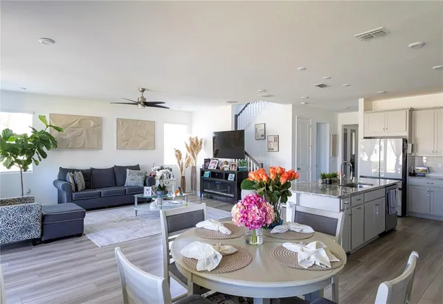 a living room with furniture and a dining room