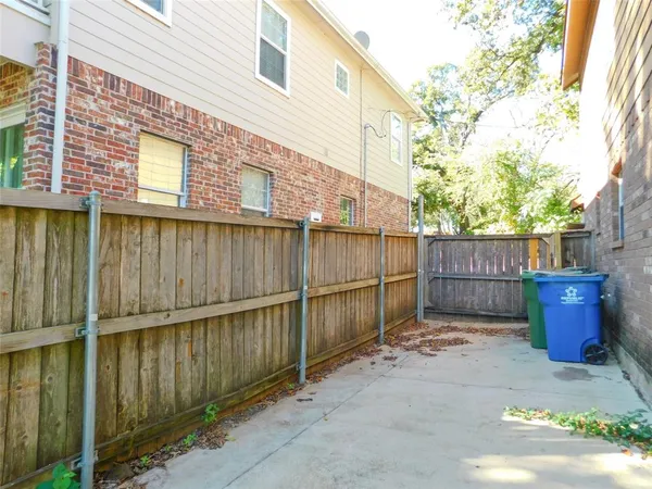 a view of a backyard with wooden fence