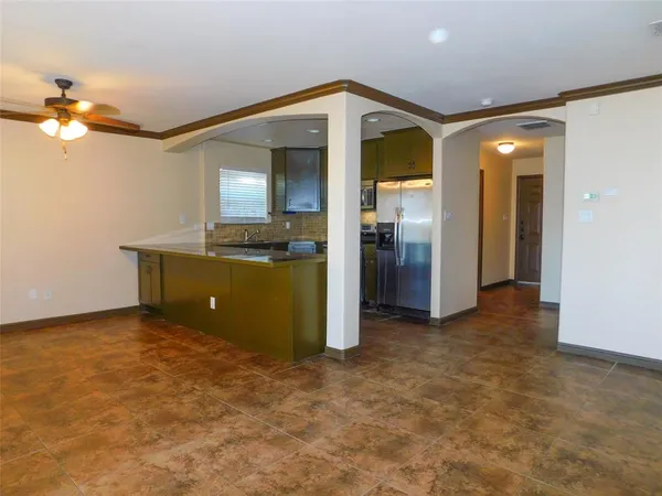 an empty room with closet and a chandelier fan