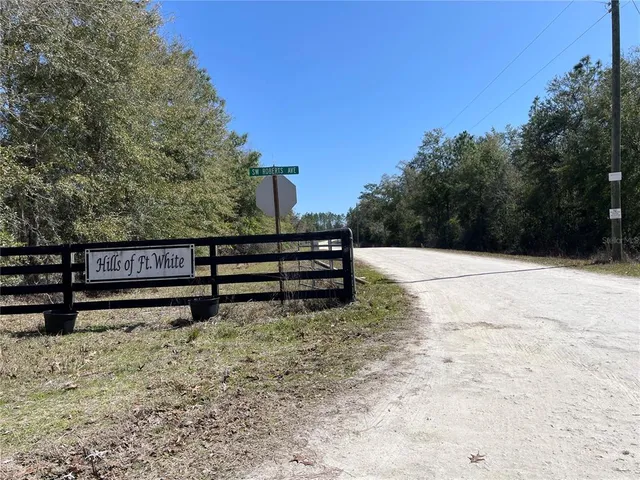 a view of a yard with wooden fence