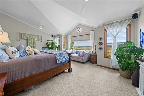 a spacious bedroom with a bed couch and a window