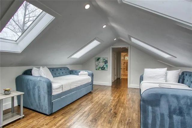 a bedroom with a large bed and a chandelier