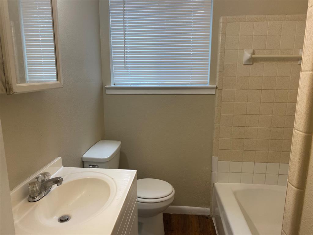 619 Arbor Lane Lancaster, TX 75134 - Photo 15 of 17 a white toilet sitting next to a bathroom sink