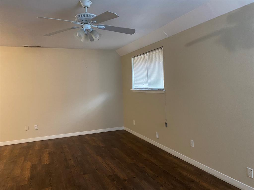 619 Arbor Lane Lancaster, TX 75134 - Photo 2 of 17 wooden floor in an empty room with a window