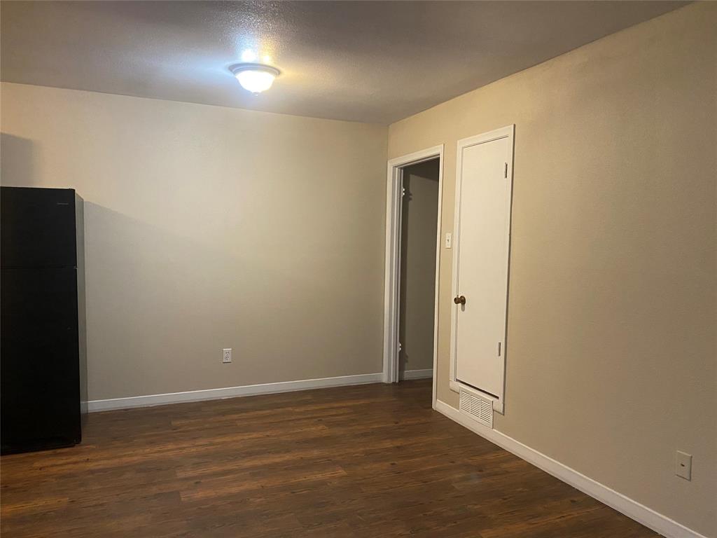 619 Arbor Lane Lancaster, TX 75134 - Photo 3 of 17 an empty room with wooden floor and windows