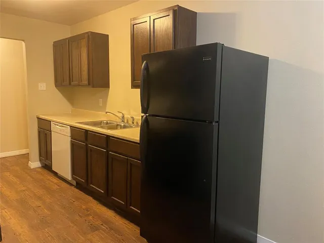 a kitchen with stainless steel appliances and refrigerator