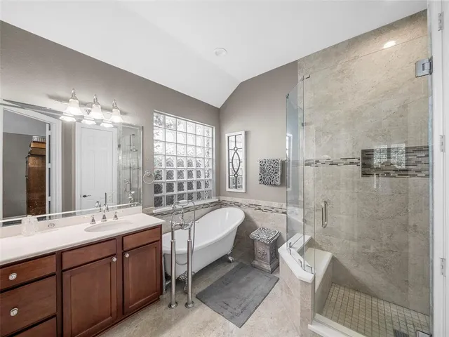 a spacious bathroom with a double vanity sink toilet and shower
