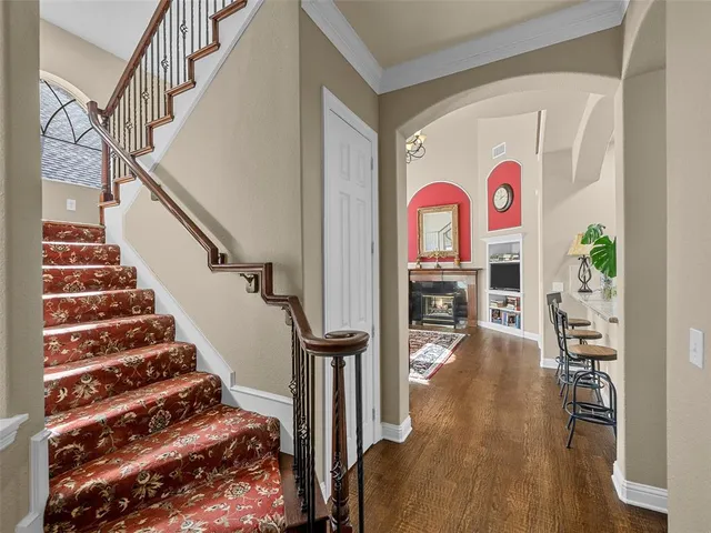 a view of entryway and hall with wooden floor