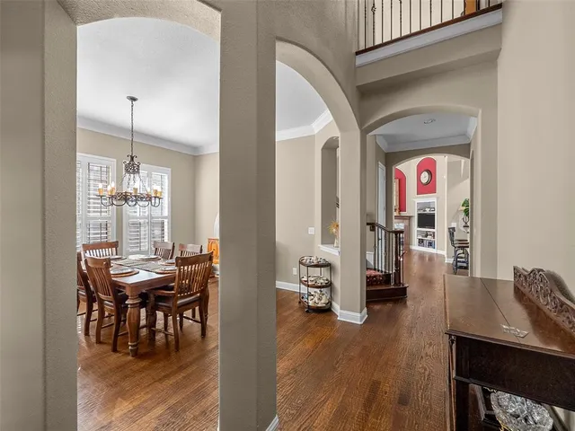 a view of a livingroom with furniture wooden floor and a chandelier