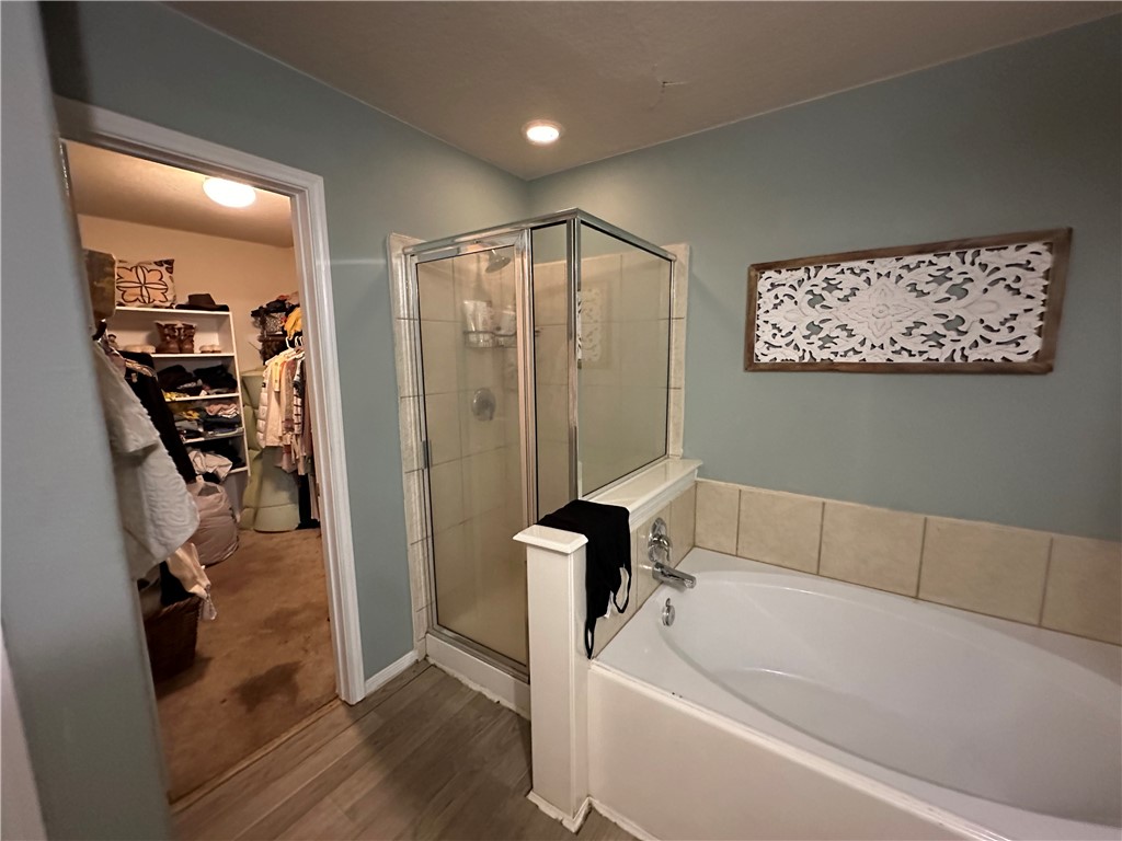 29475 Forest Spring Spring, TX 77373 - Photo 7 of 10 a bathroom with a tub a window and a shower