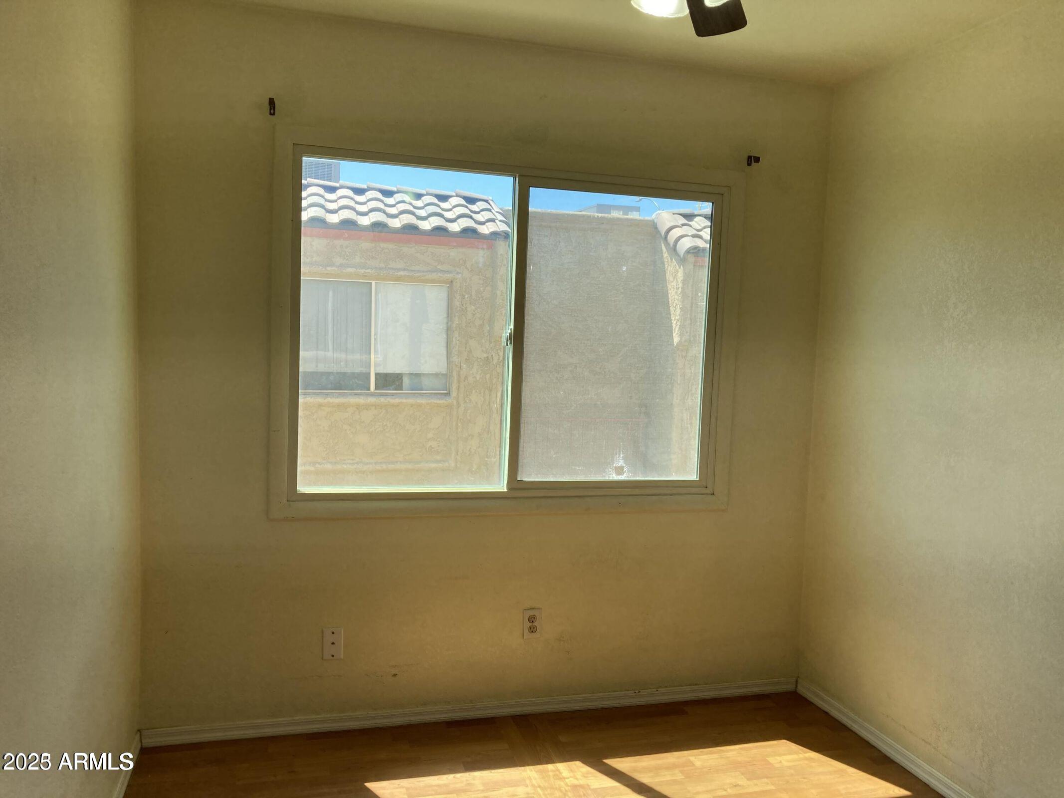 948 South Alma School Road, Unit 102 Mesa, AZ 85210 - Photo 8 of 13 a view of an empty room with a window