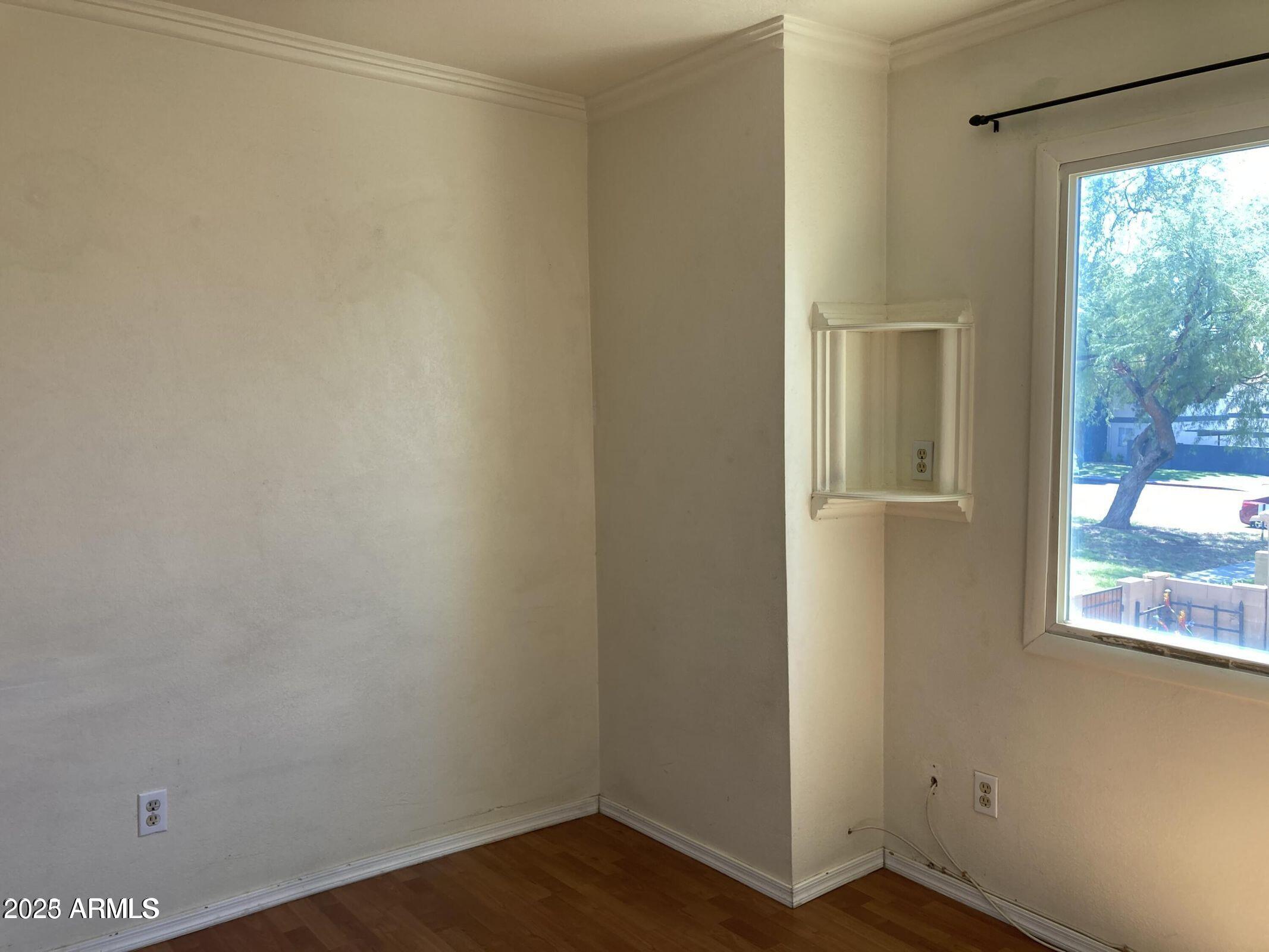 948 South Alma School Road, Unit 102 Mesa, AZ 85210 - Photo 9 of 13 a view of a small space with wooden floor and a window