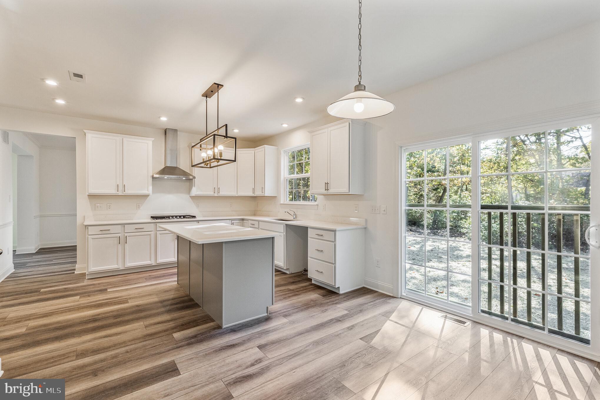 317 Ferrell Road Mullica Hill, NJ 08062 - Photo 14 of 31 a large kitchen with kitchen island a large counter space a sink appliances and cabinets