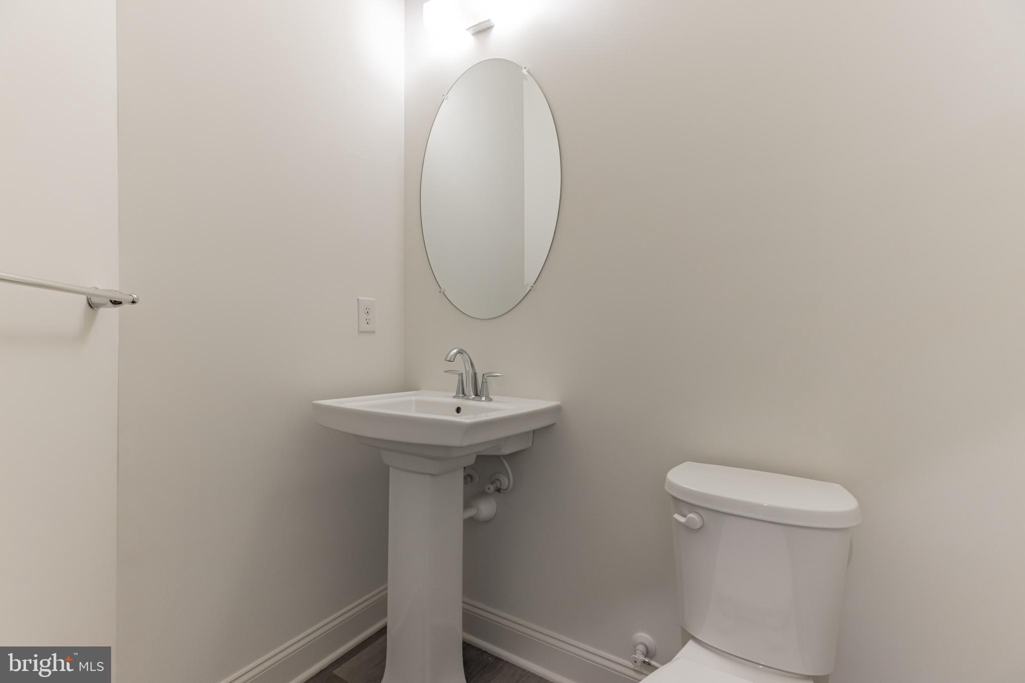 317 Ferrell Road Mullica Hill, NJ 08062 - Photo 17 of 31 a bathroom with a sink a toilet and a mirror
