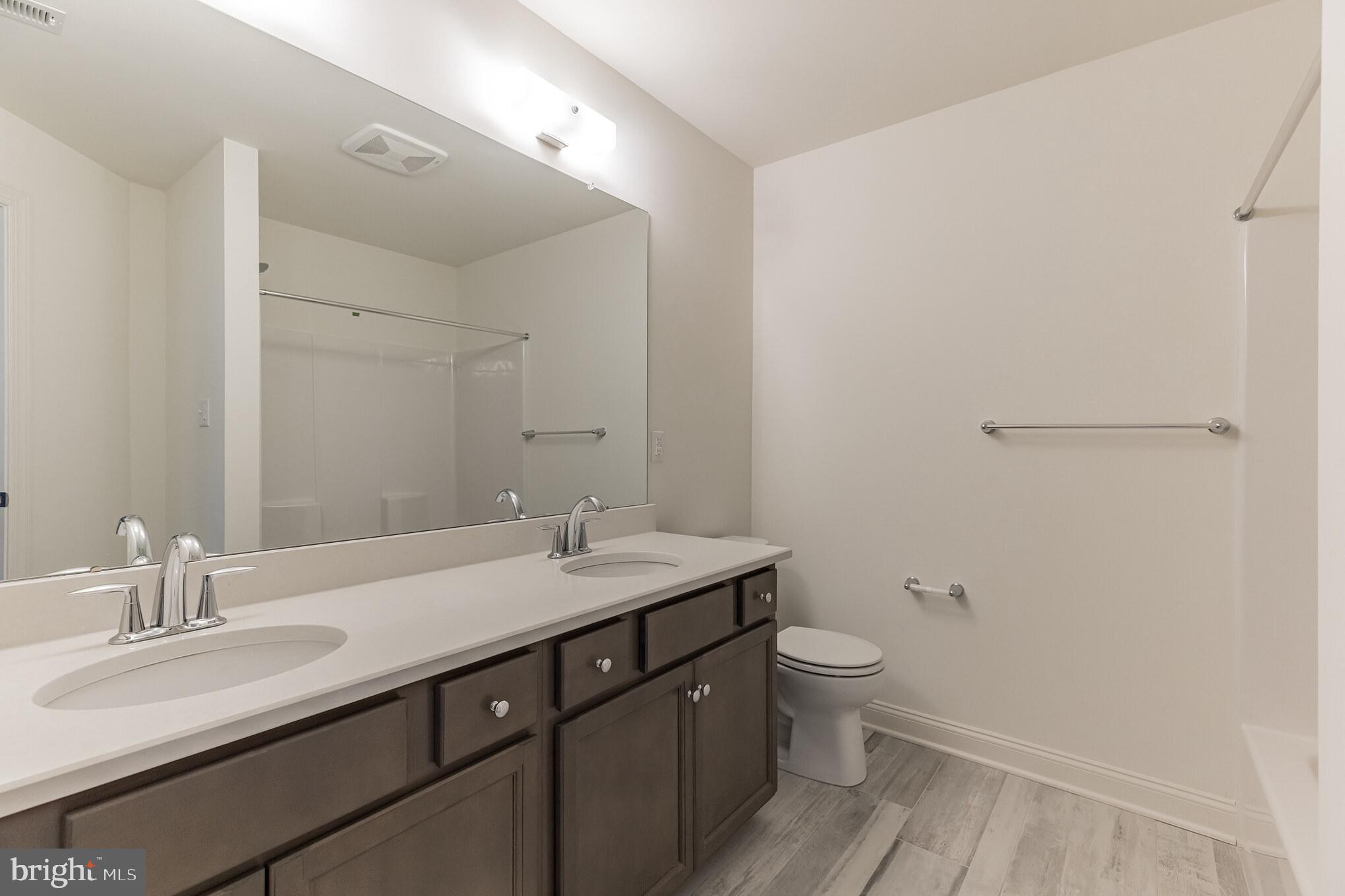 317 Ferrell Road Mullica Hill, NJ 08062 - Photo 27 of 31 a bathroom with a sink a toilet a shower and a mirror