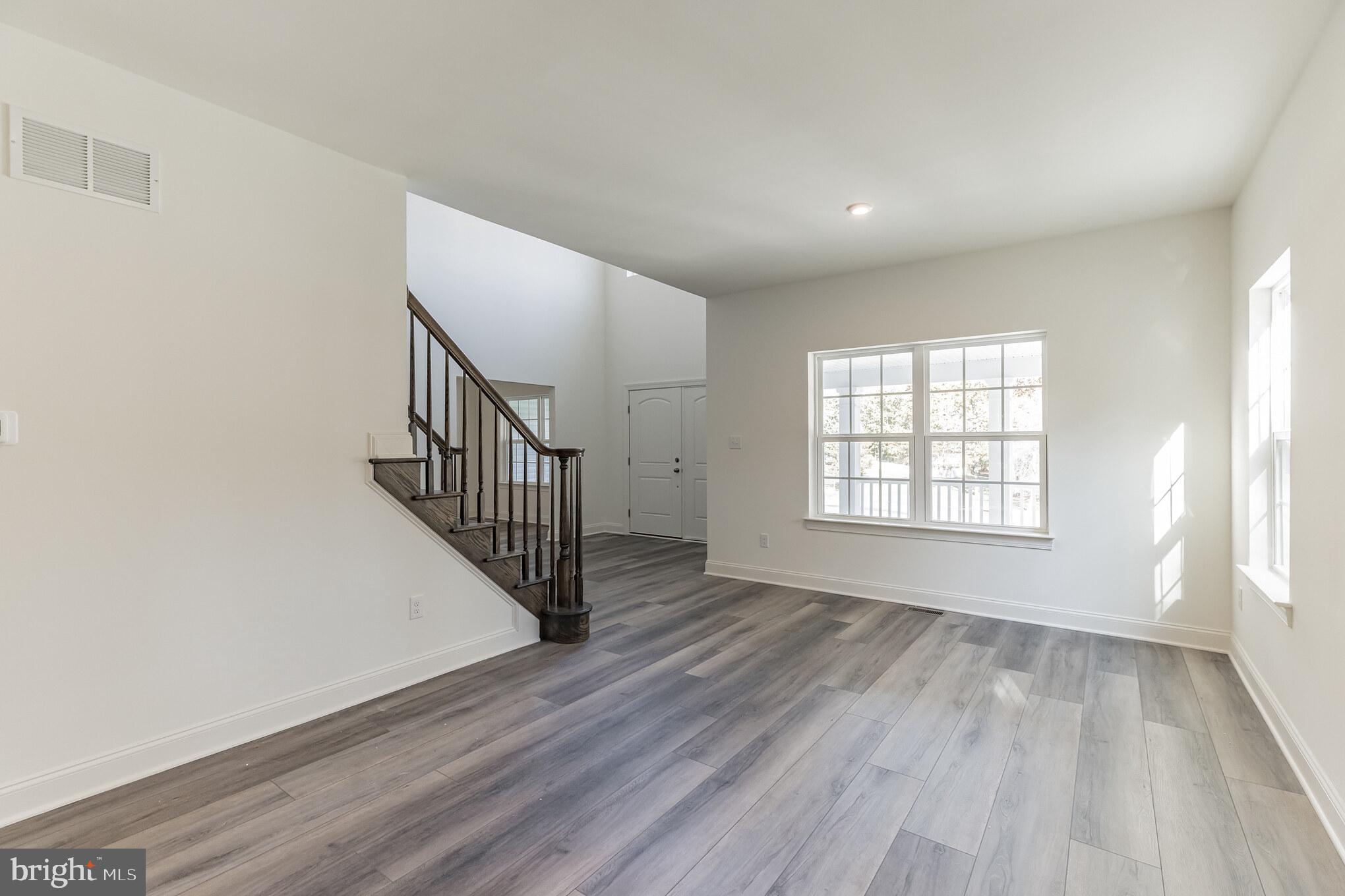 317 Ferrell Road Mullica Hill, NJ 08062 - Photo 6 of 31 wooden floor in an empty room with a window