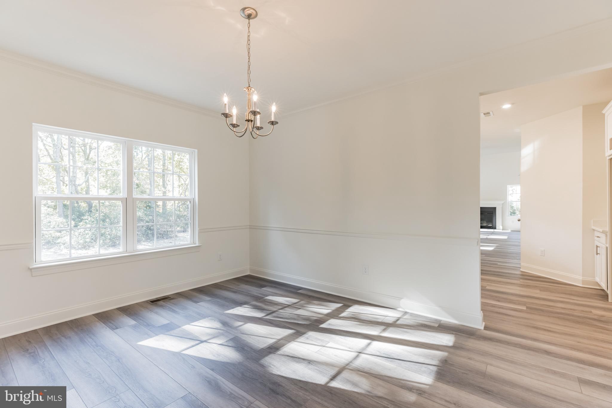 317 Ferrell Road Mullica Hill, NJ 08062 - Photo 7 of 31 a view of empty room with wooden floor and fan