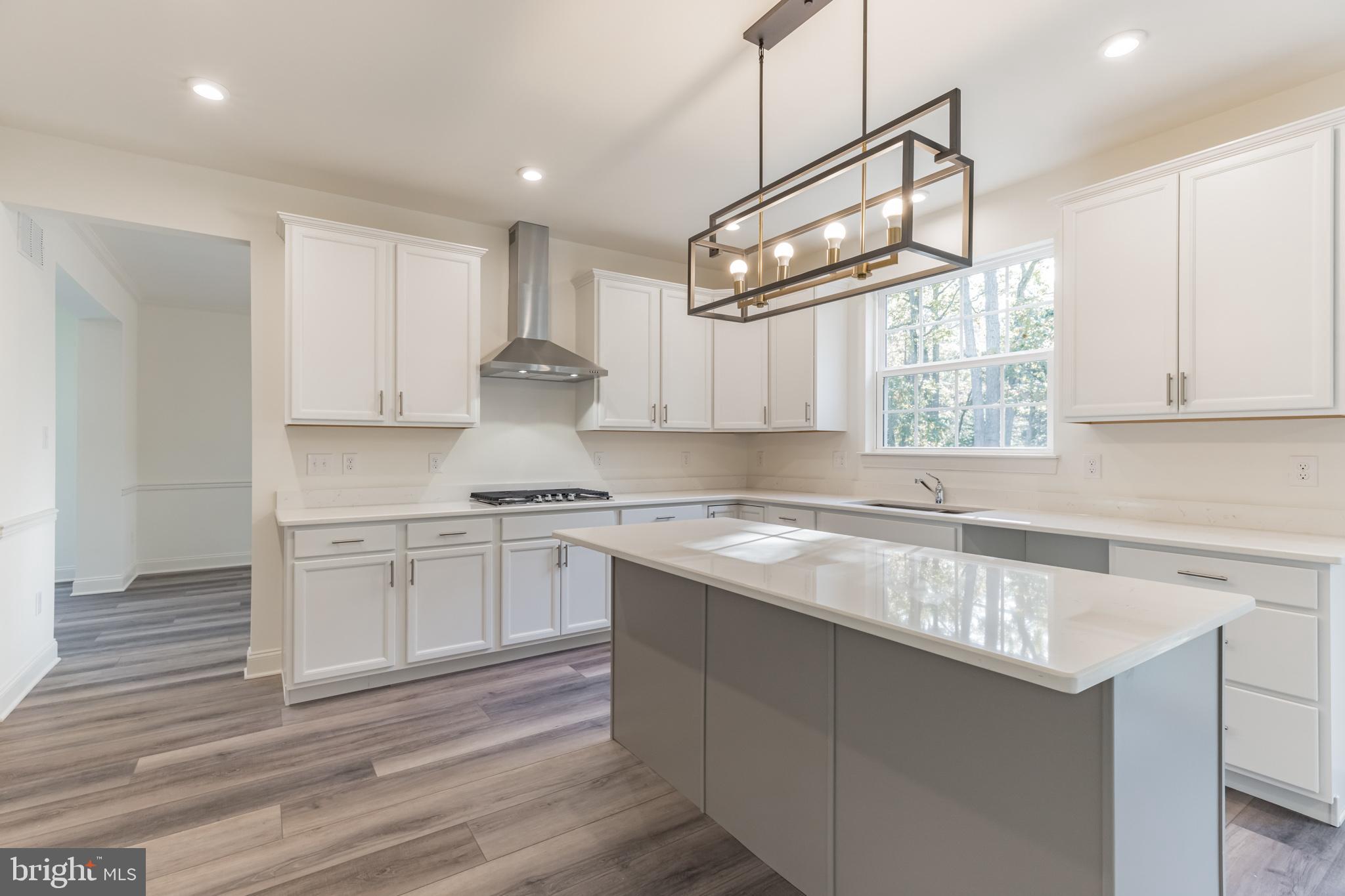 317 Ferrell Road Mullica Hill, NJ 08062 - Photo 10 of 31 a kitchen with a sink cabinets appliances and a window