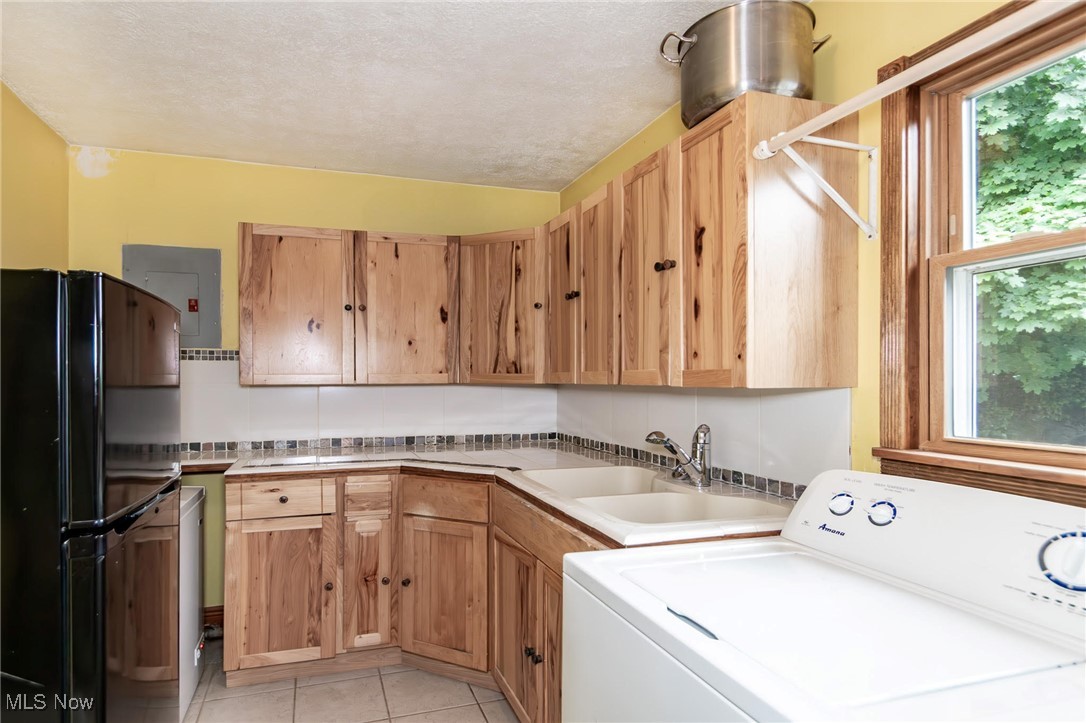 5081 Middle Ridge Road Perry, OH 44081 - Photo 25 of 33 Laundry room with washer / clothes dryer, healthy amount of natural light, light tile patterned floors, and electric panel