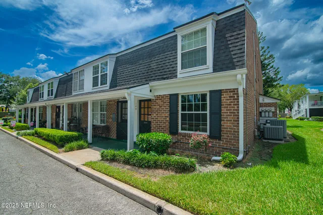 a view of a house with a yard and plants