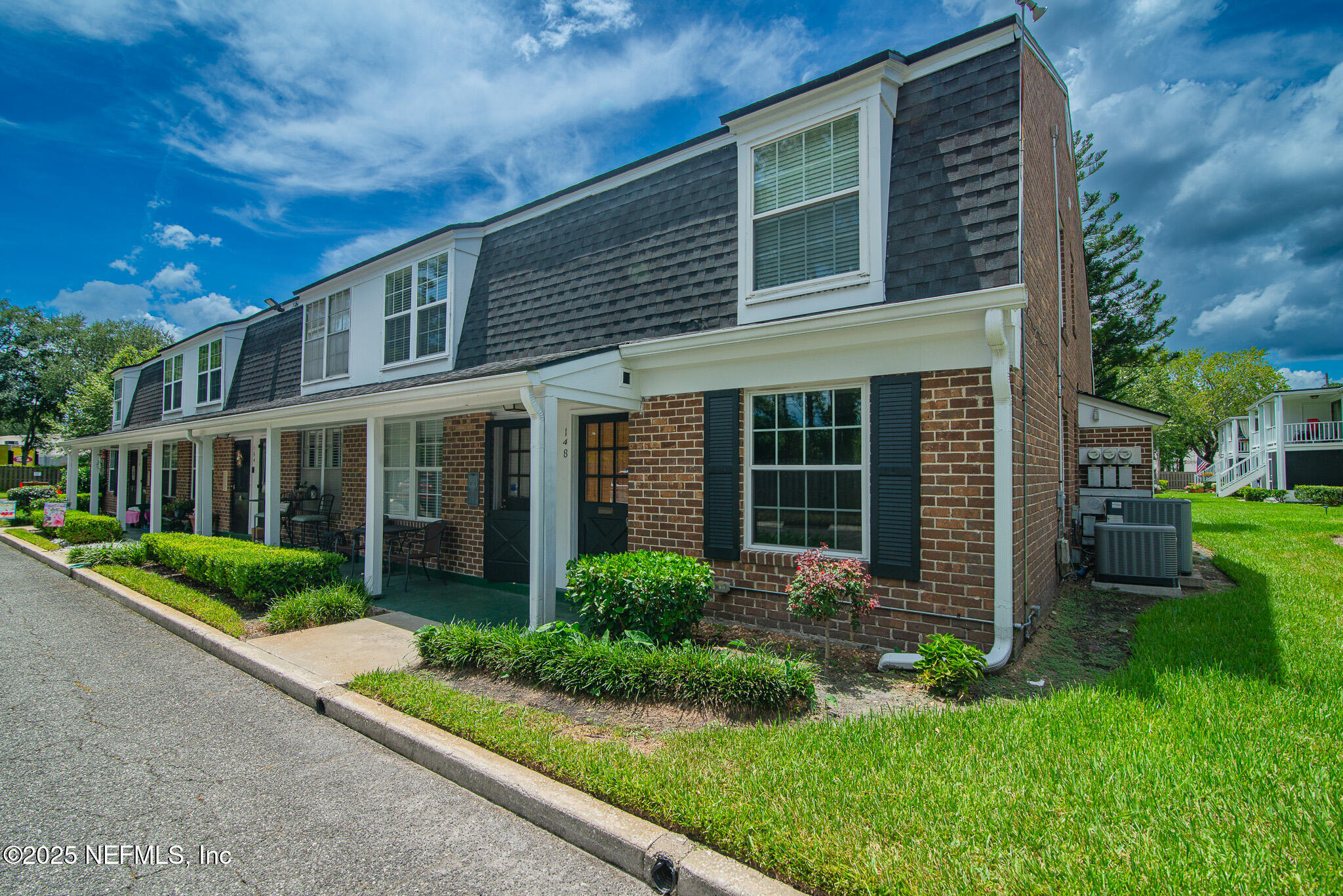 a view of a house with a yard and plants