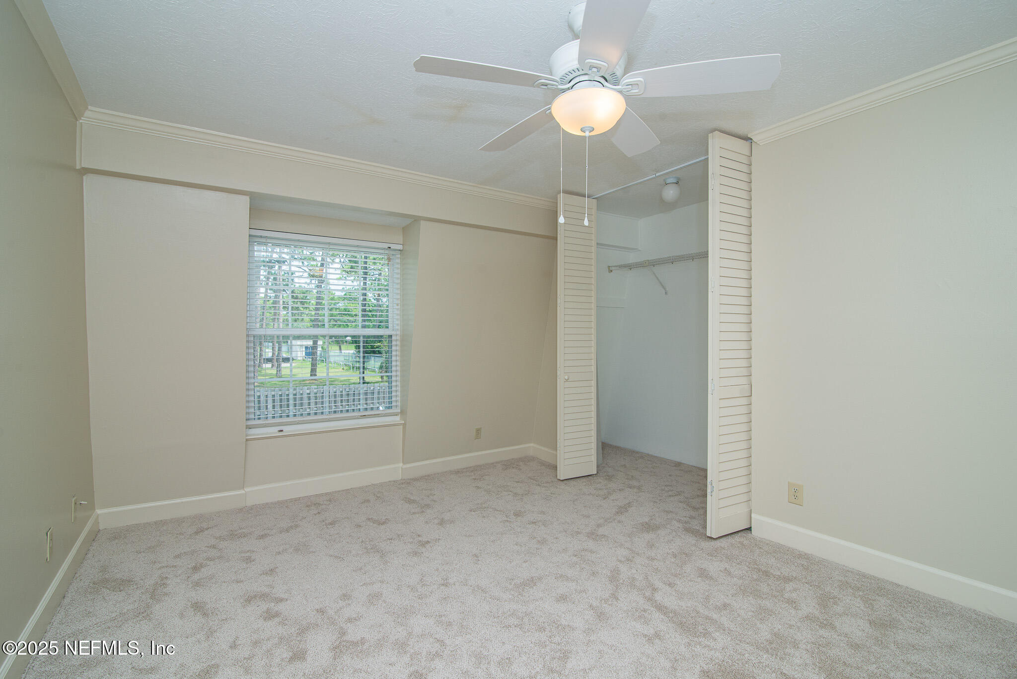 4358 Timuquana Road, Unit 148 Jacksonville, FL 32210 - Photo 13 of 22 an empty room with fan and windows
