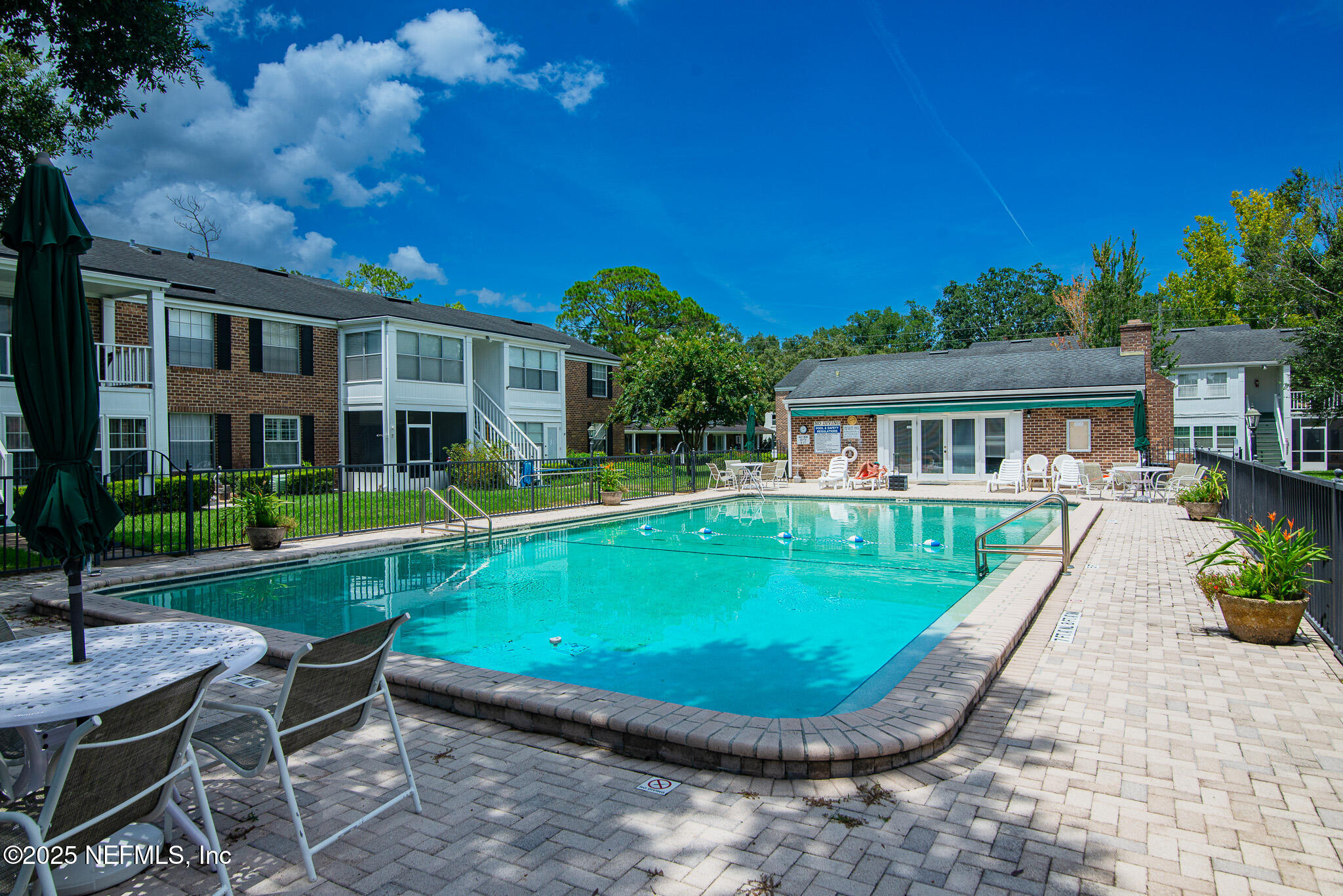 4358 Timuquana Road, Unit 148 Jacksonville, FL 32210 - Photo 3 of 22 a view of a house with pool fire pit a table and chairs