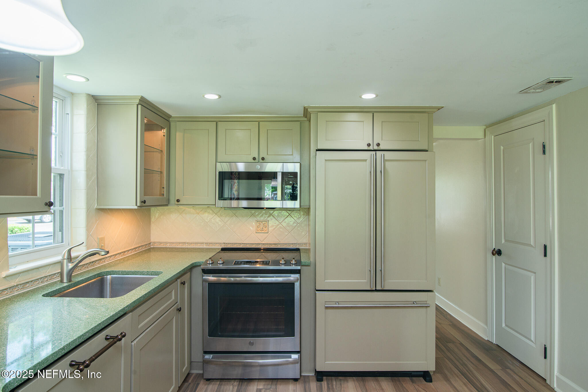 4358 Timuquana Road, Unit 148 Jacksonville, FL 32210 - Photo 4 of 22 a kitchen with stainless steel appliances granite countertop a refrigerator a stove and a sink
