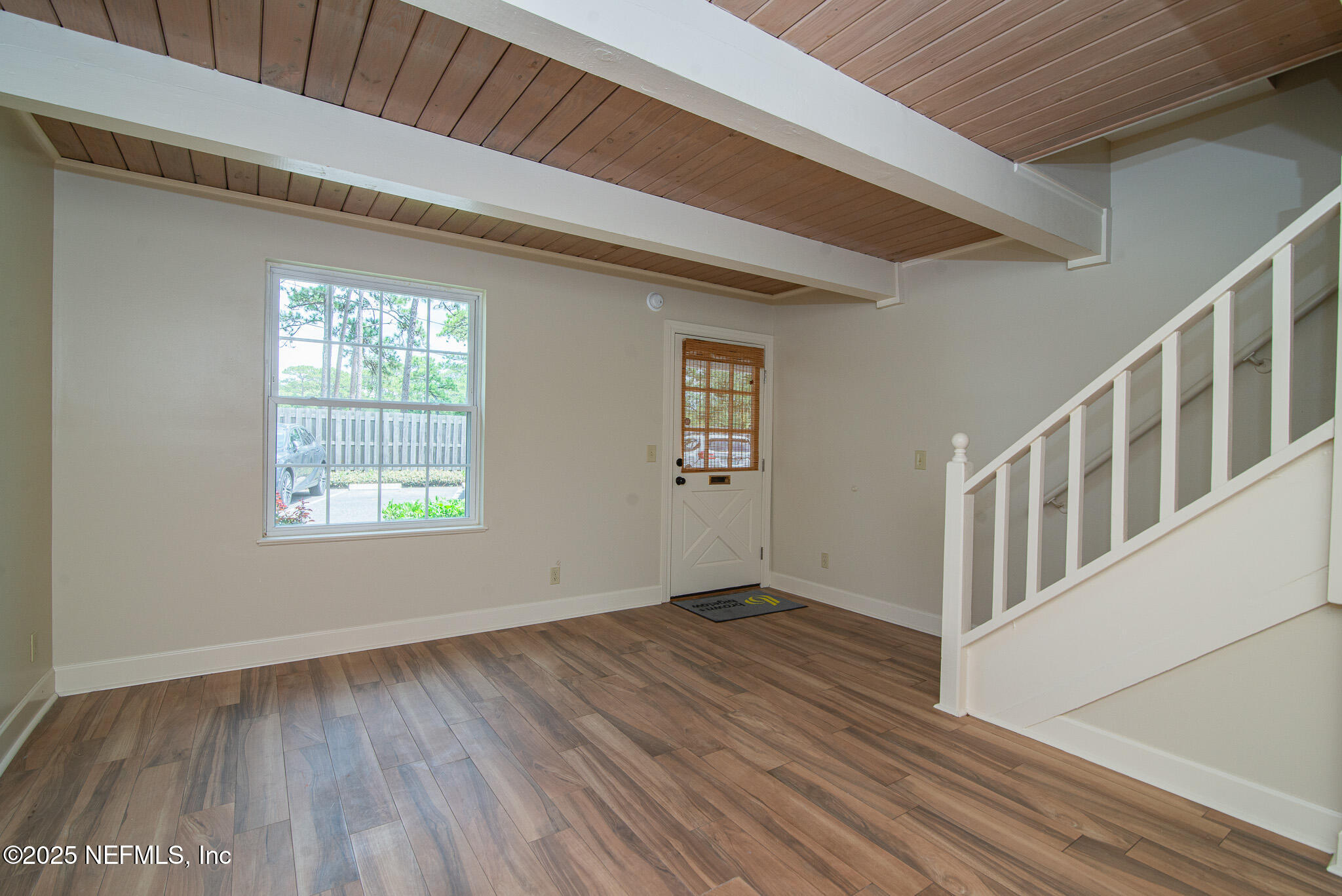 4358 Timuquana Road, Unit 148 Jacksonville, FL 32210 - Photo 6 of 22 a view of an empty room with wooden floor and a window