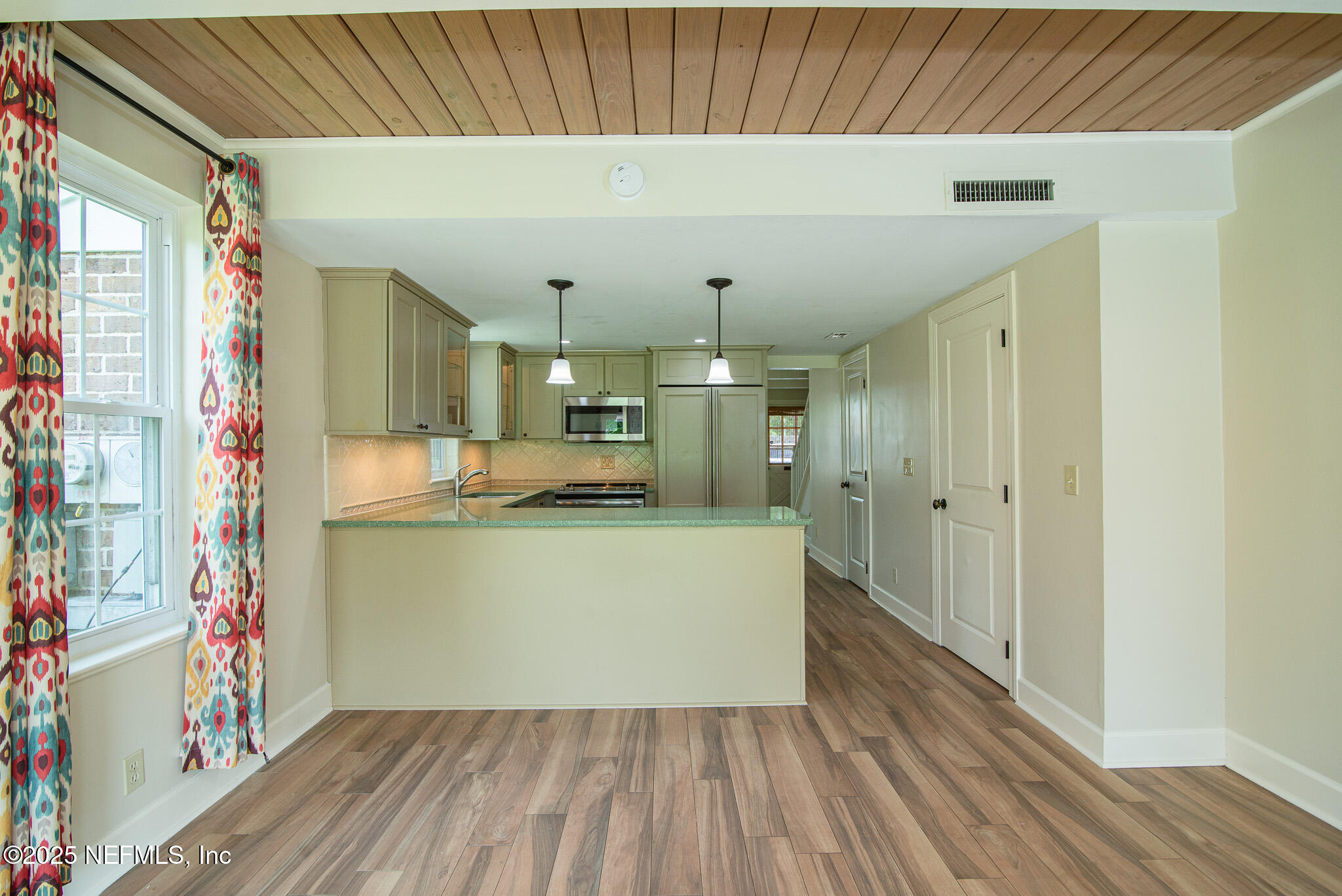 4358 Timuquana Road, Unit 148 Jacksonville, FL 32210 - Photo 7 of 22 a room with kitchen island wooden floors and stainless steel appliances