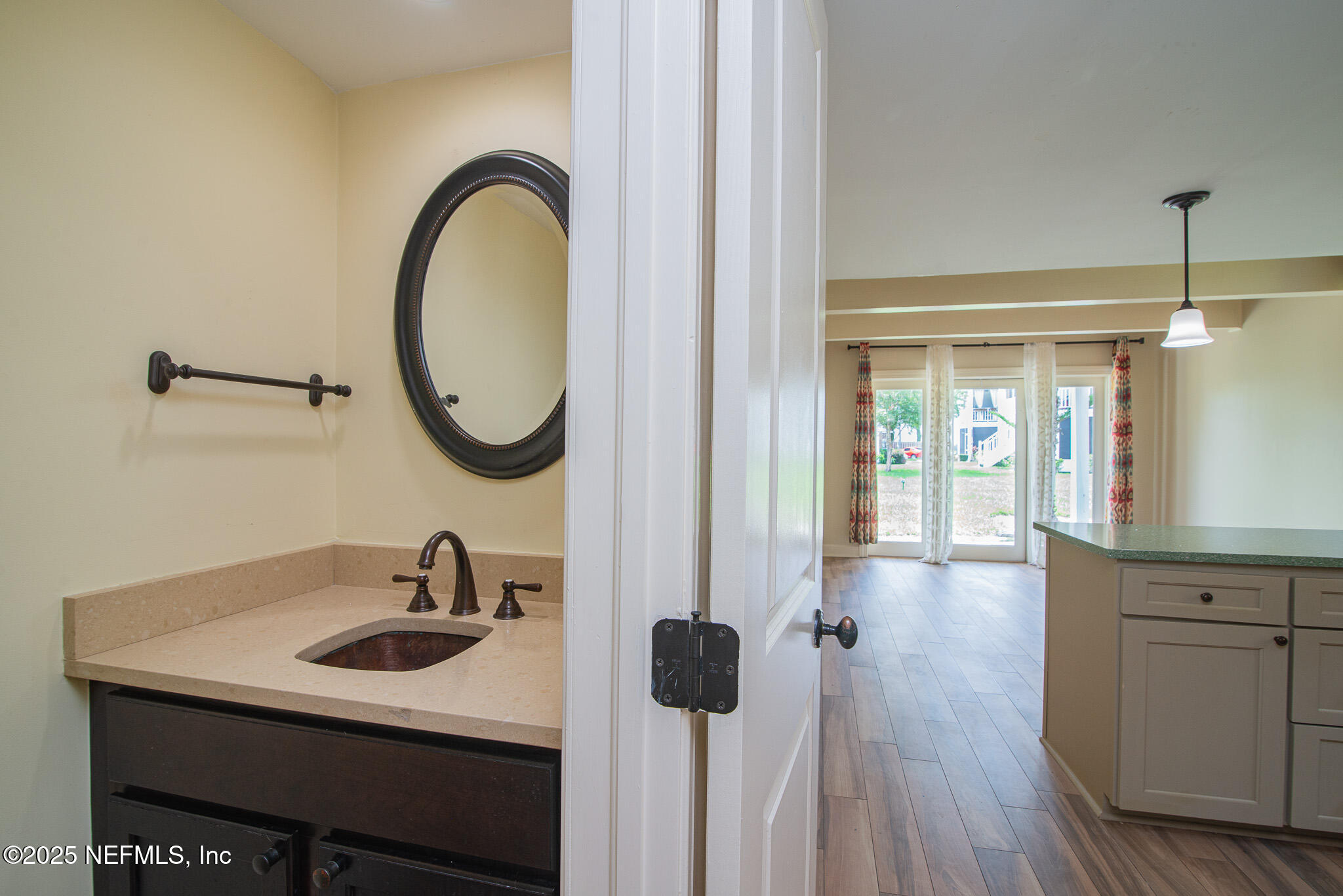 4358 Timuquana Road, Unit 148 Jacksonville, FL 32210 - Photo 10 of 22 a bathroom with a sink and mirror with wooden floor
