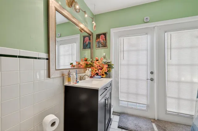 a bathroom with a sink vanity and a mirror