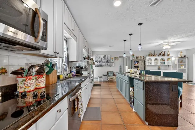 a kitchen with stainless steel appliances granite countertop lots of counter top space