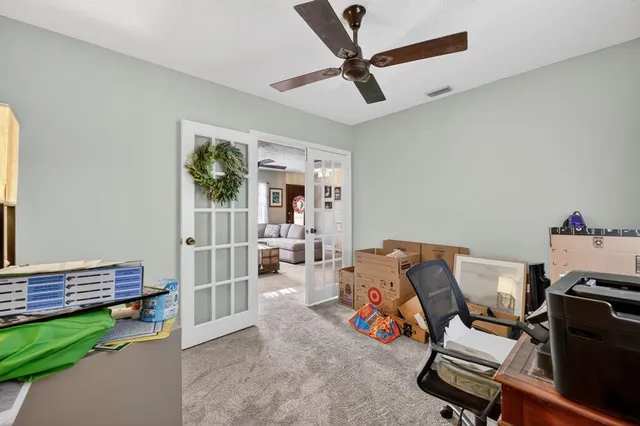 a view of a workspace with furniture and a window