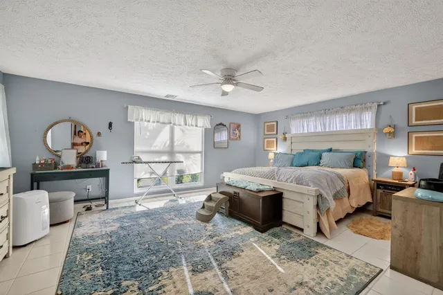 a living room with furniture a table and large window