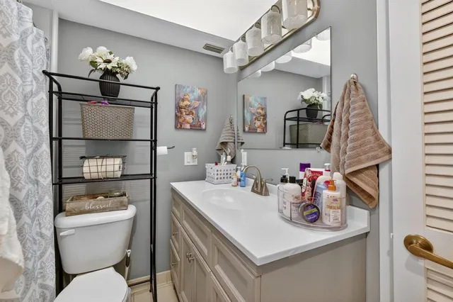 a bathroom with a sink a toilet and a mirror