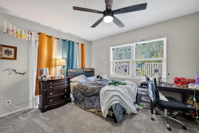 a bedroom with a bed a large dresser and a window